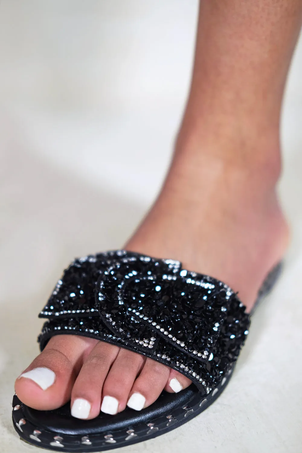 LORNA WIDE FIT DIAMANTE BOW FLAT SLIDERS WITH STUD DETAILS IN BLACK